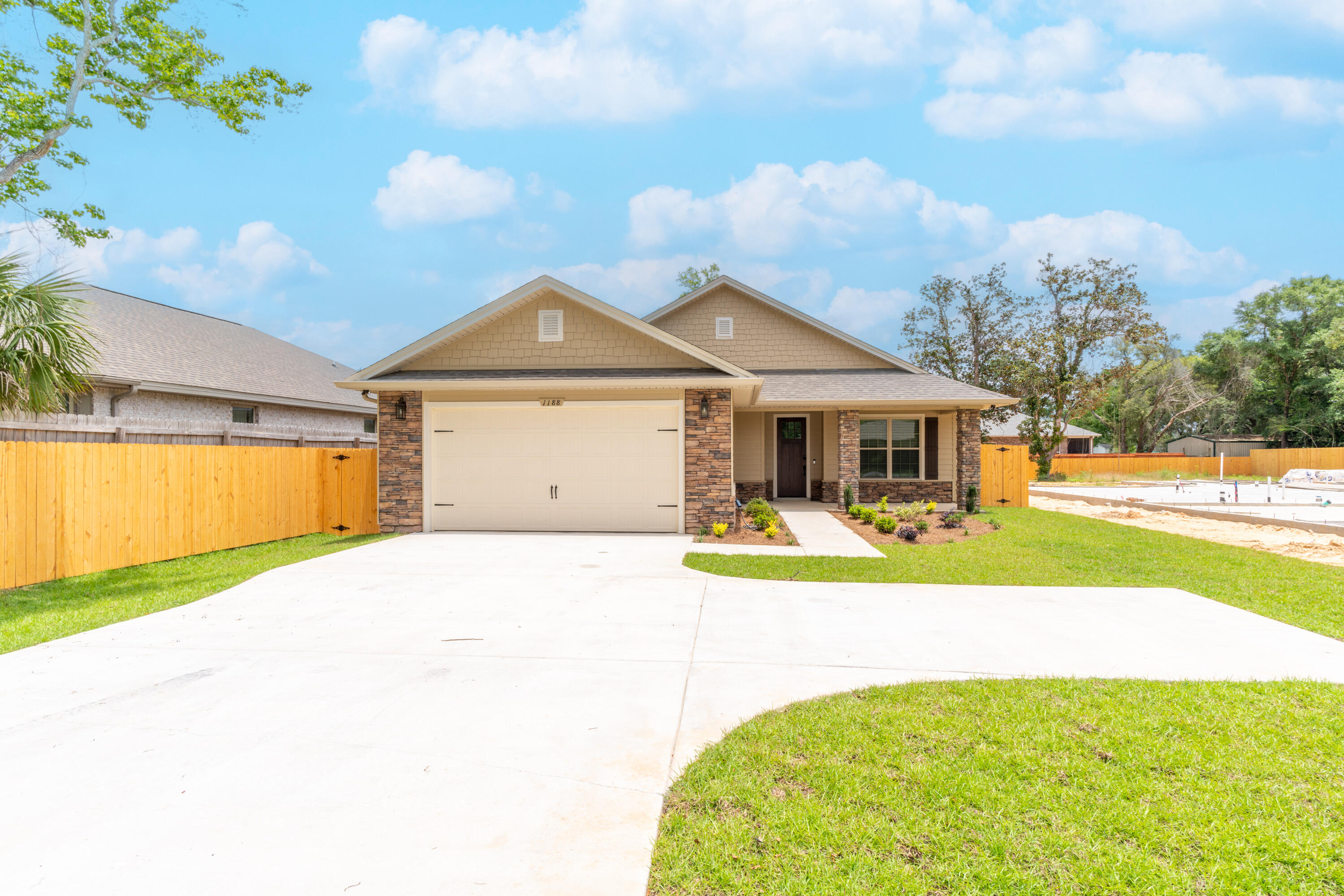 a front view of a house with swimming pool having outdoor seating