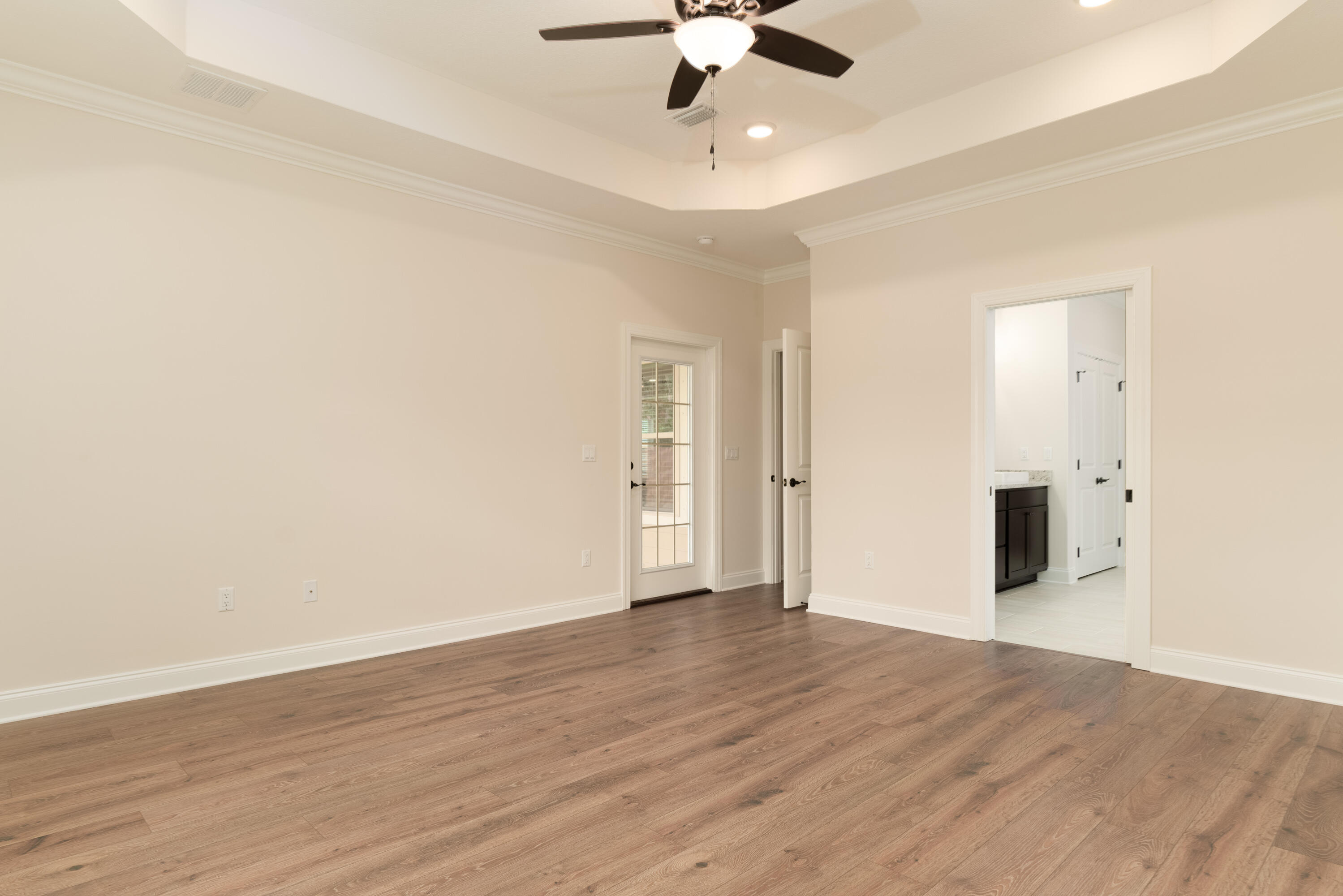 1184 Forest Heights Road Fort Walton Beach, FL 32547 - Photo 17 of 45 an empty room with a ceiling fan and wooden floor