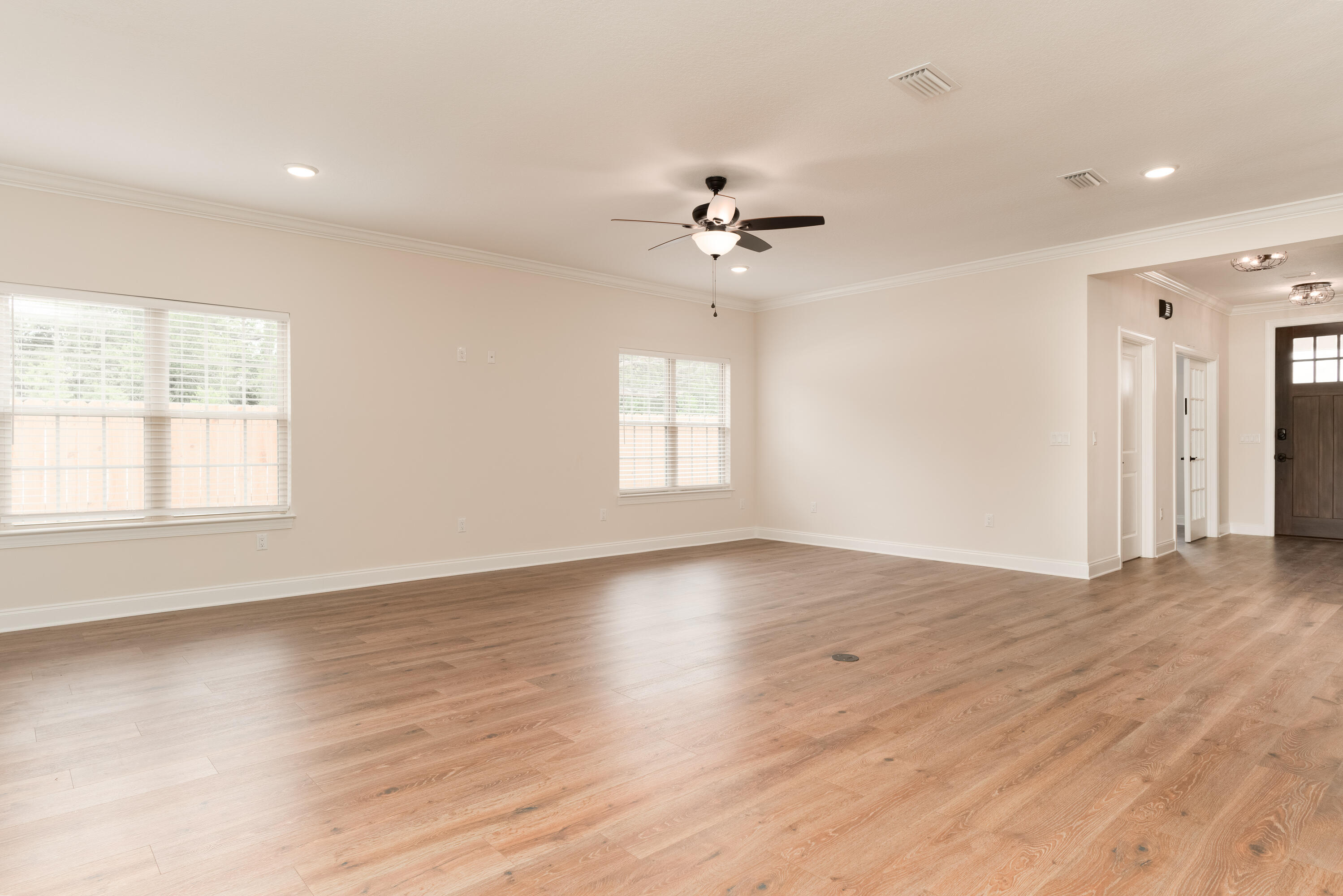 1184 Forest Heights Road Fort Walton Beach, FL 32547 - Photo 20 of 45 a view of an empty room with a window and wooden floor