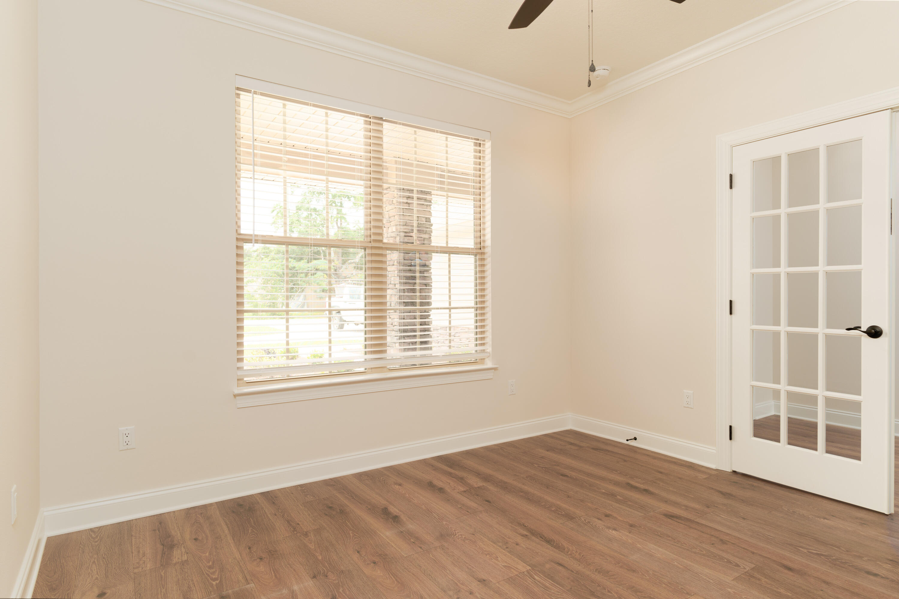 1184 Forest Heights Road Fort Walton Beach, FL 32547 - Photo 21 of 45 an empty room with wooden floor and windows