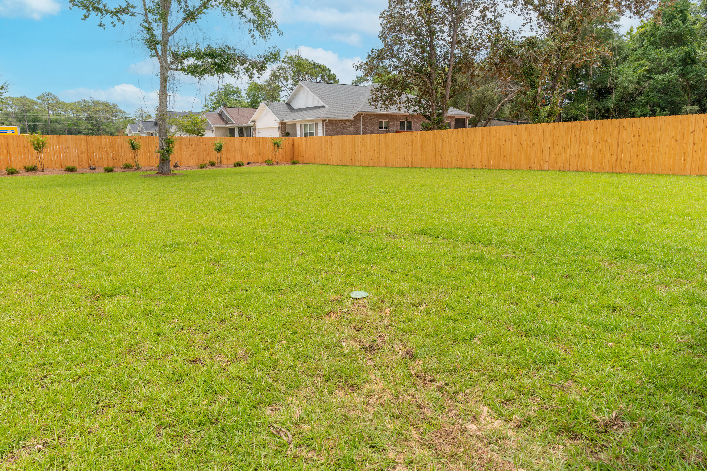 1184 Forest Heights Road Fort Walton Beach, FL 32547 - Photo 32 of 45 a view of a field with an ocean view