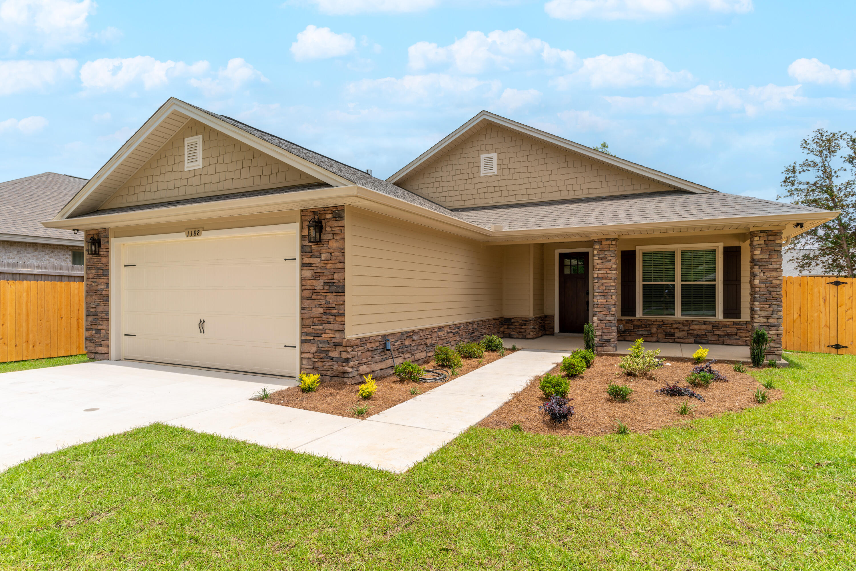 1184 Forest Heights Road Fort Walton Beach, FL 32547 - Photo 42 of 45 a front view of a house with a yard outdoor seating and garage