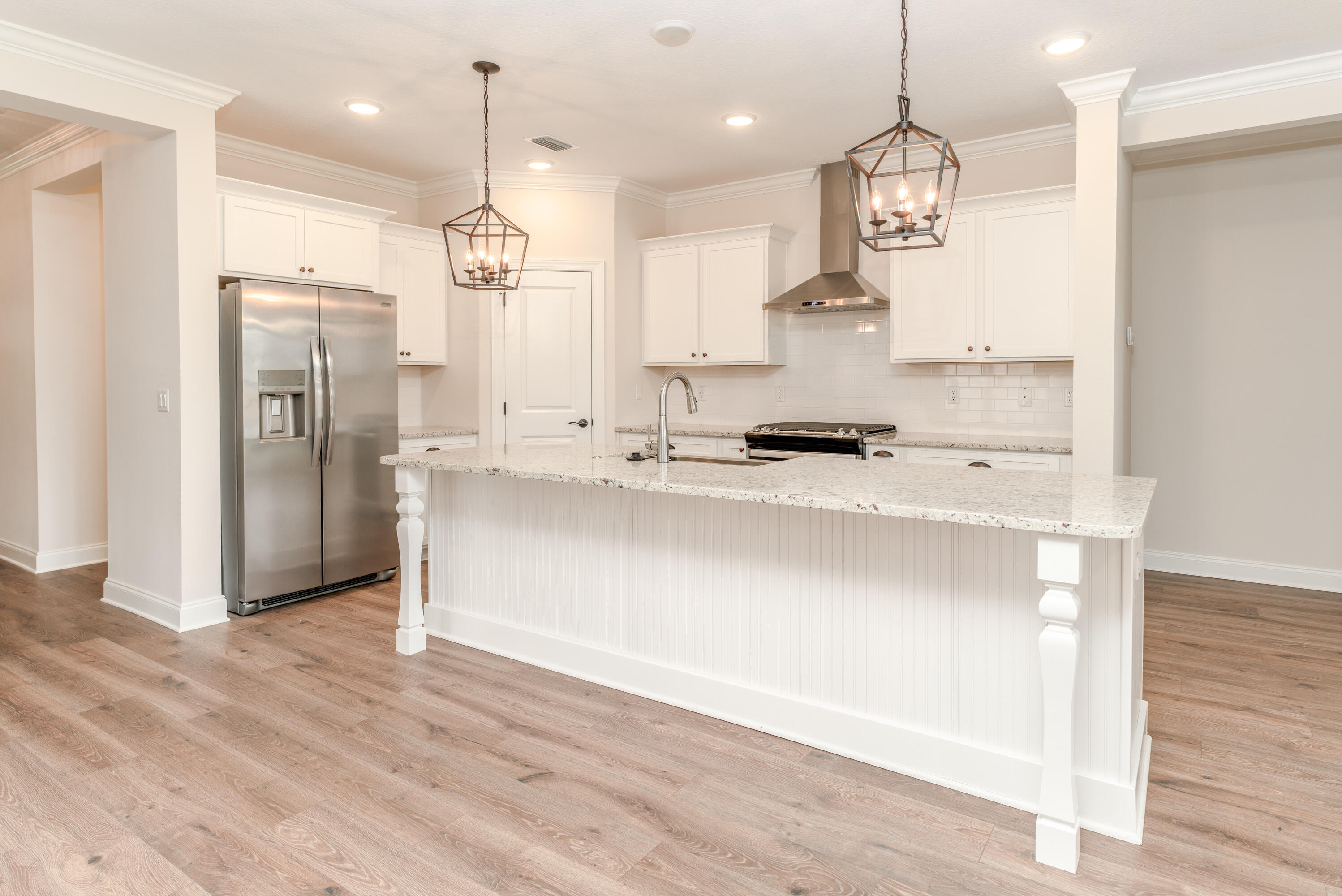 1184 Forest Heights Road Fort Walton Beach, FL 32547 - Photo 8 of 45 a kitchen with kitchen island stainless steel appliances sink cabinets and wooden floor