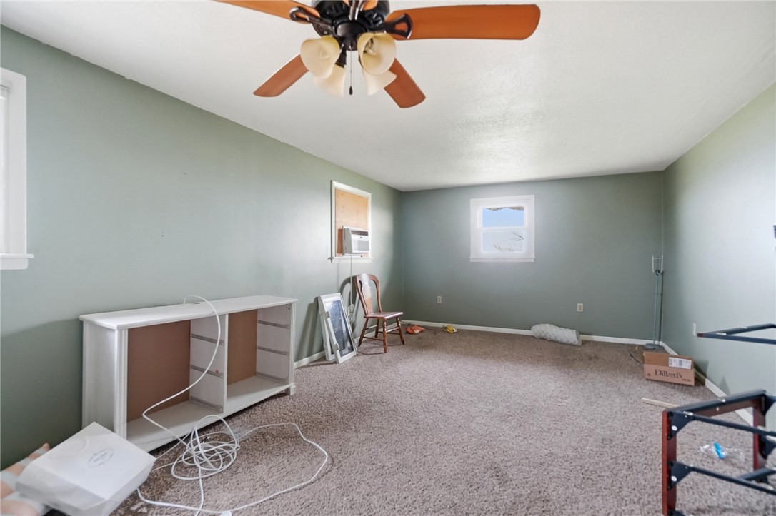 9750 Middlepoint Road Middle Point, OH 45863 - Photo 18 of 43 This versatile room features carpet flooring and a ceiling fan, offering comfort and adaptable living.
