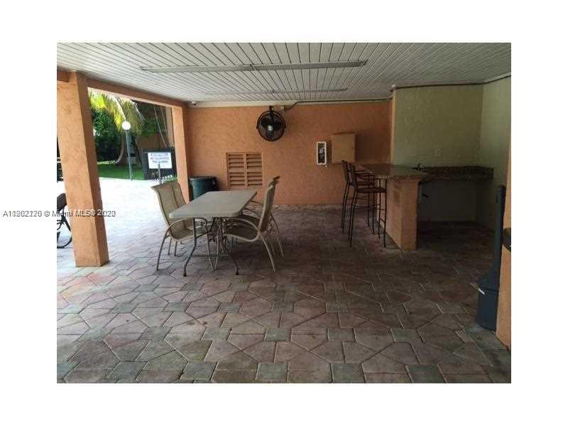 2150 Southwest 16th Avenue, Unit 409 Miami, FL 33145 - Photo 3 of 6 a view of a dining room with furniture and a window