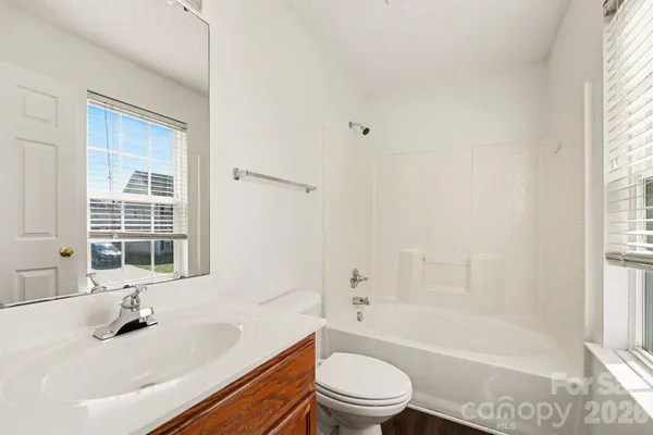 a bathroom with a sink toilet tub and shower