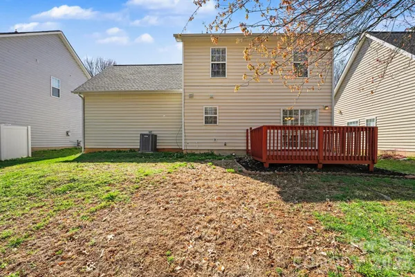 a view of backyard with wooden fence