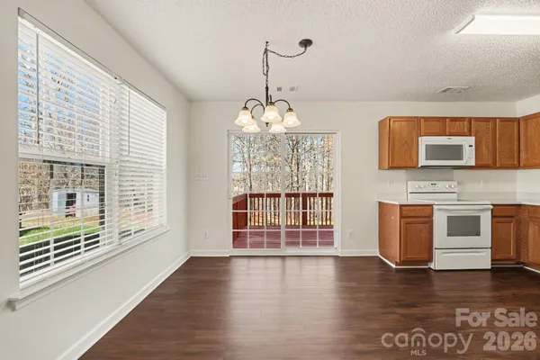 a view of a kitchen with a sink wooden floor and a window