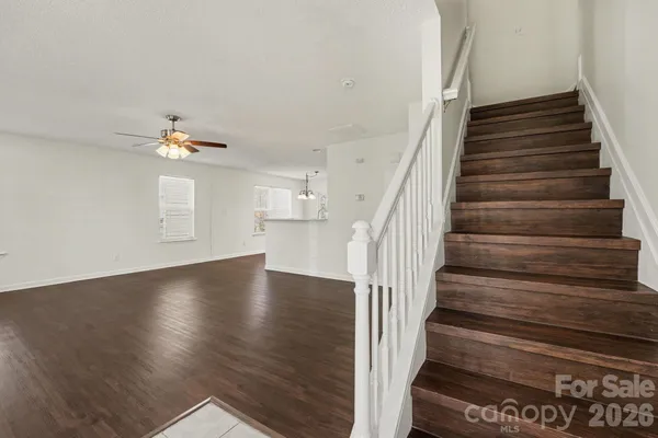 a view of entryway and hall with wooden floor