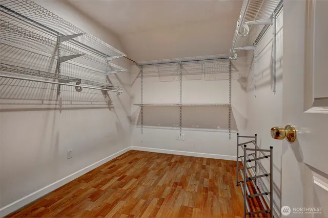 a view of a room with wooden floor and windows