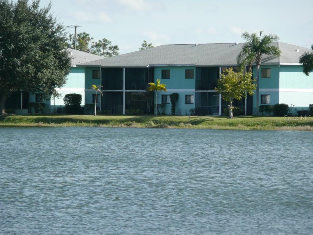25225 Rampart Boulevard, Unit 304 Punta Gorda, FL 33983 - Photo 1 of 1 a front view of a house with a yard