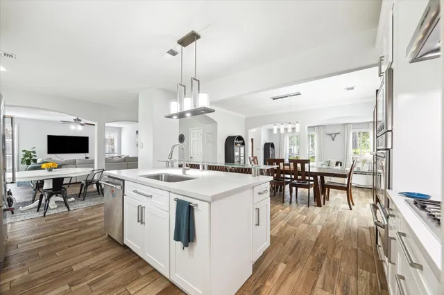 a kitchen with a stove a table and chairs