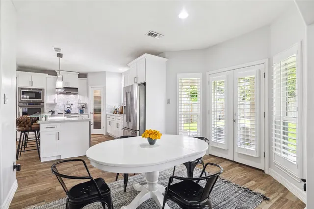 a kitchen with a table and chairs in it