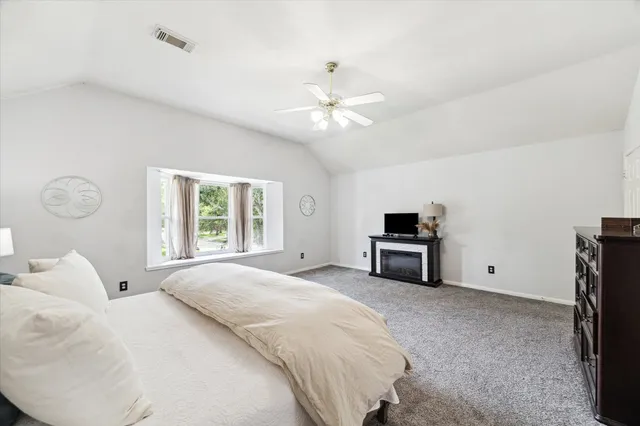 a bedroom with bed and a tv