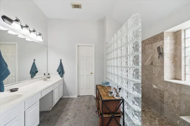 a bathroom with double vanity sink and mirror