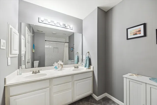 a bathroom with a double vanity sink and a mirror
