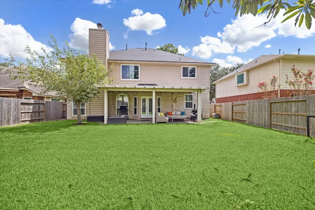 a view of a house with a backyard and a patio