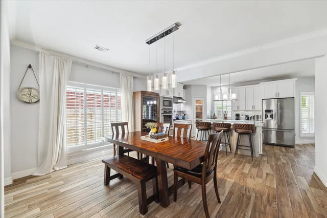a view of a dining room with furniture window and wooden floor
