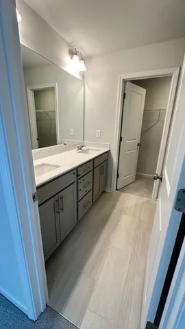 a bathroom with a double vanity sink and mirror