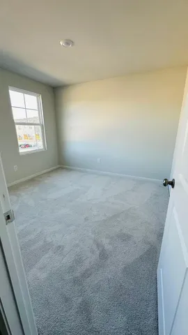 a view of an empty room and a window