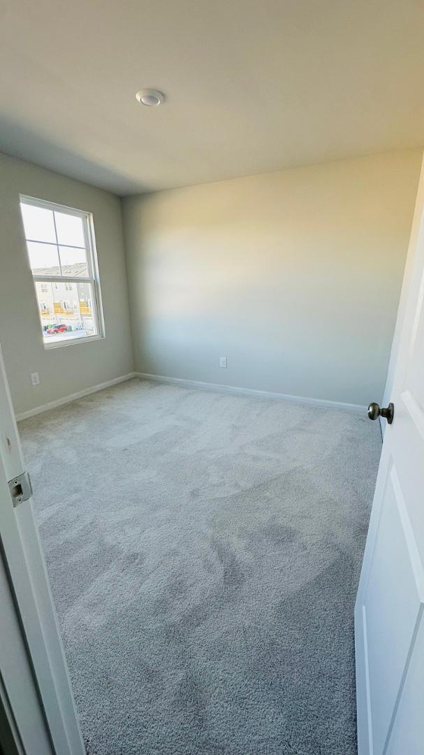 114 Red Brush Way Apex, NC 27539 - Photo 14 of 22 a view of an empty room and a window