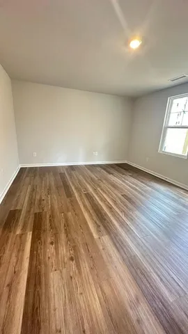 wooden floor in a hall with an empty room