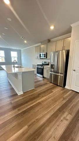 a view of kitchen with refrigerator microwave and stove