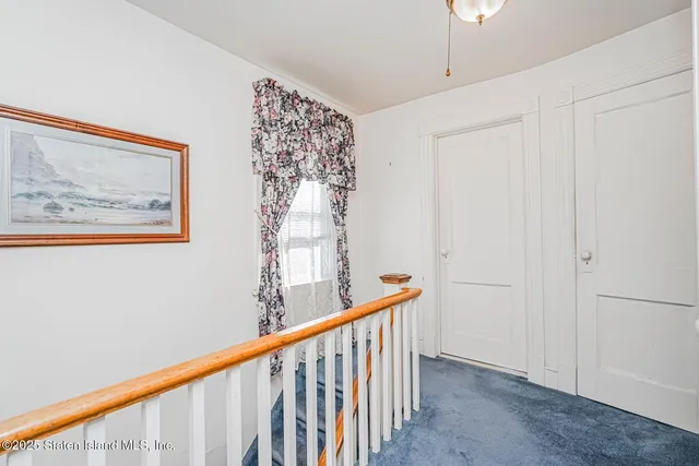 a view of staircase with rug