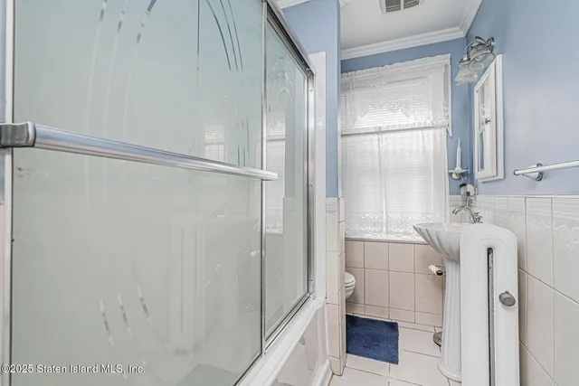 a bathroom with a shower and a sink