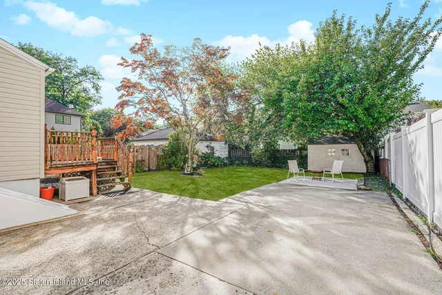front view of a house with a yard and an trees