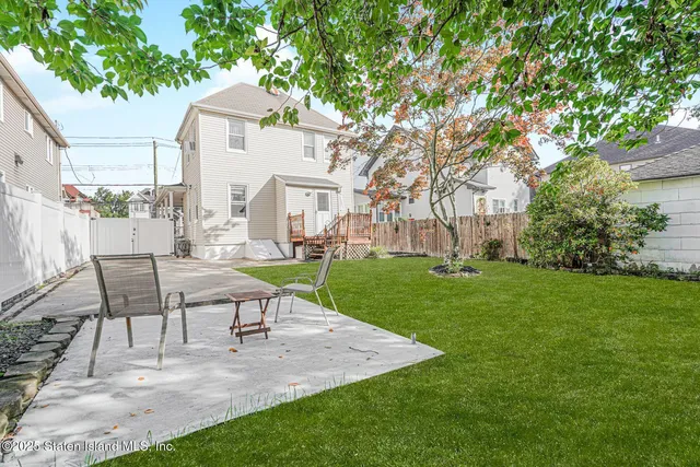 a view of a house with a yard and sitting area