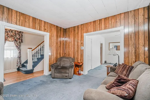 a living room with furniture and a entryway
