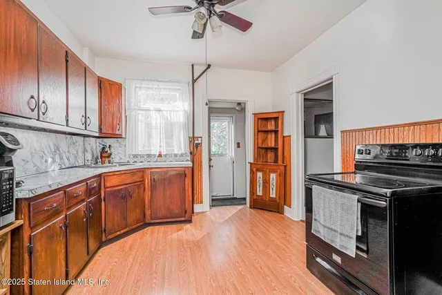 a kitchen with stainless steel appliances granite countertop a stove refrigerator and cabinets