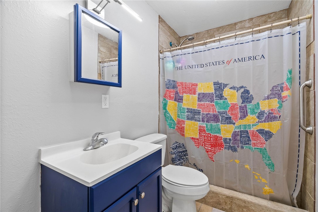 519 Claride Street Corpus Christi, TX 78418 - Photo 11 of 15 a bathroom with a sink toilet and shower