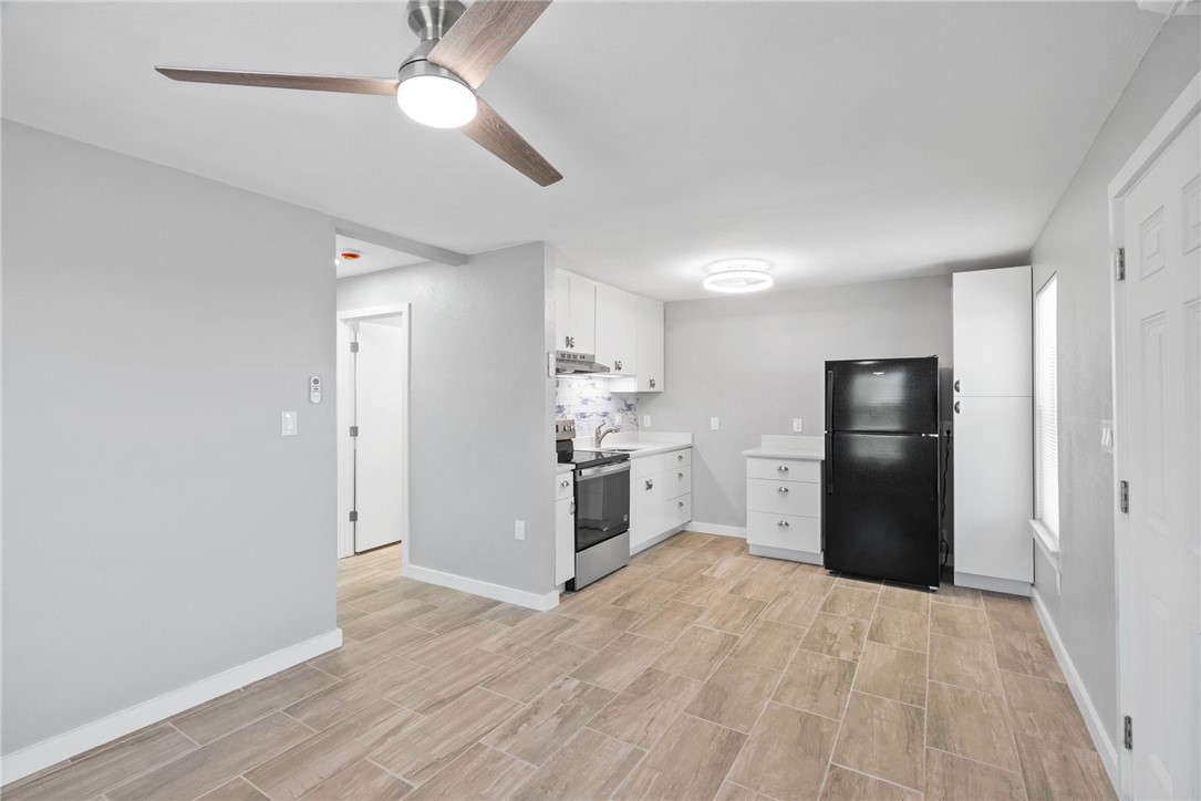 519 Claride Street Corpus Christi, TX 78418 - Photo 2 of 15 a kitchen with stainless steel appliances a refrigerator and a chandelier