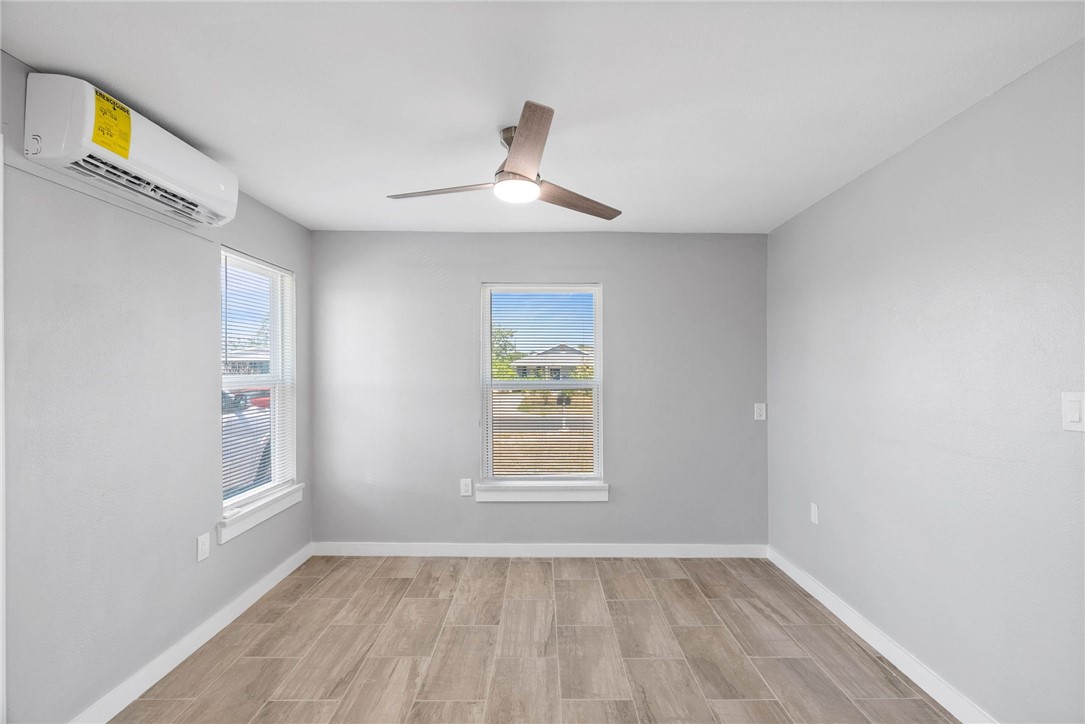 519 Claride Street Corpus Christi, TX 78418 - Photo 4 of 15 a view of an empty room with a window and wooden floor