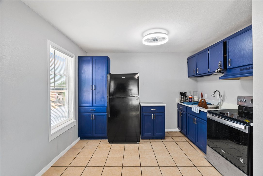 519 Claride Street Corpus Christi, TX 78418 - Photo 9 of 15 a kitchen with stainless steel appliances granite countertop a stove a refrigerator and a sink