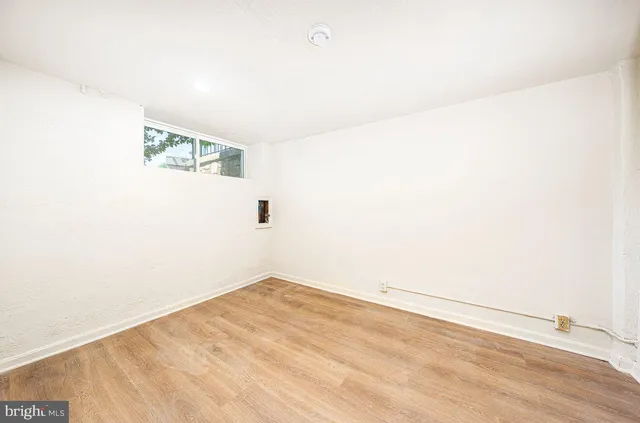 a view of a room with wooden floor