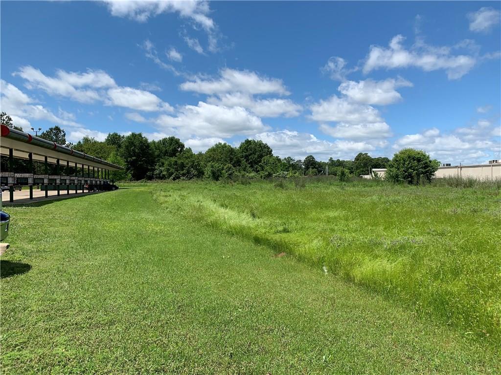 0 Mansfield Road Shreveport, LA 71108 - Photo 4 of 10 a view of a green field with sitting in the background