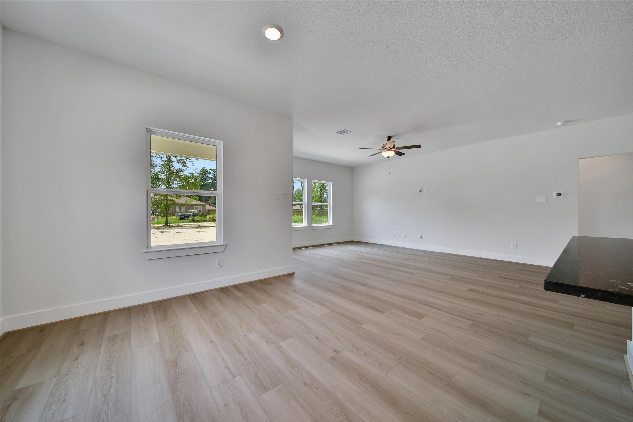 1003 Thor New Caney, TX 77357 - Photo 11 of 45 an empty room with wooden floor and windows