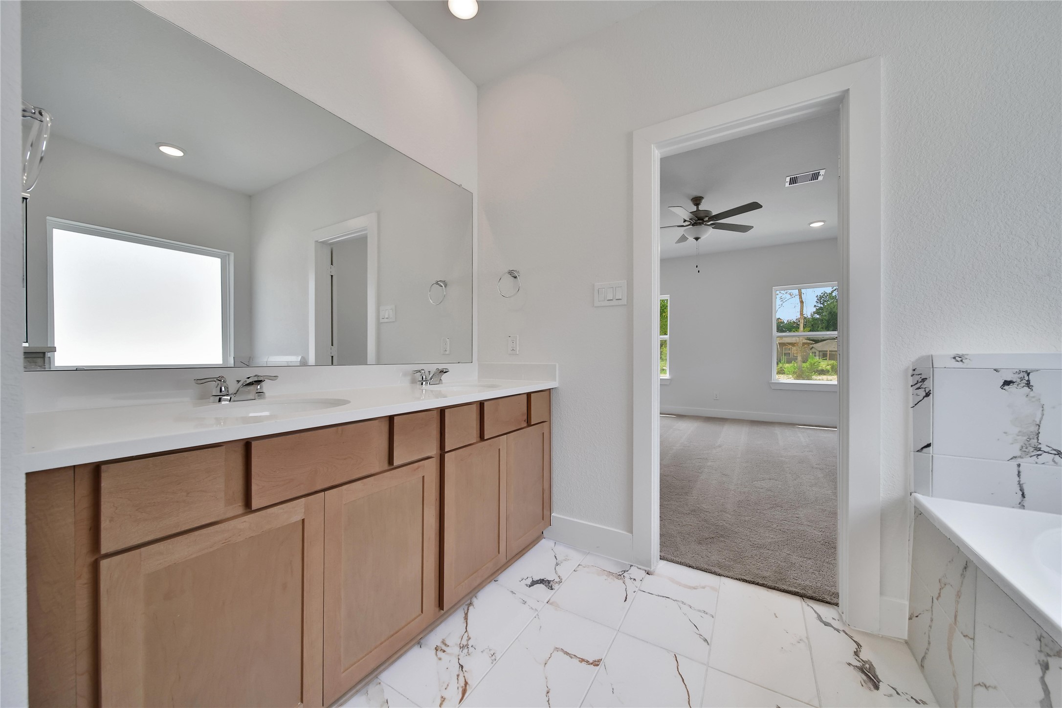1003 Thor New Caney, TX 77357 - Photo 16 of 45 a bathroom with a double vanity sink and mirror