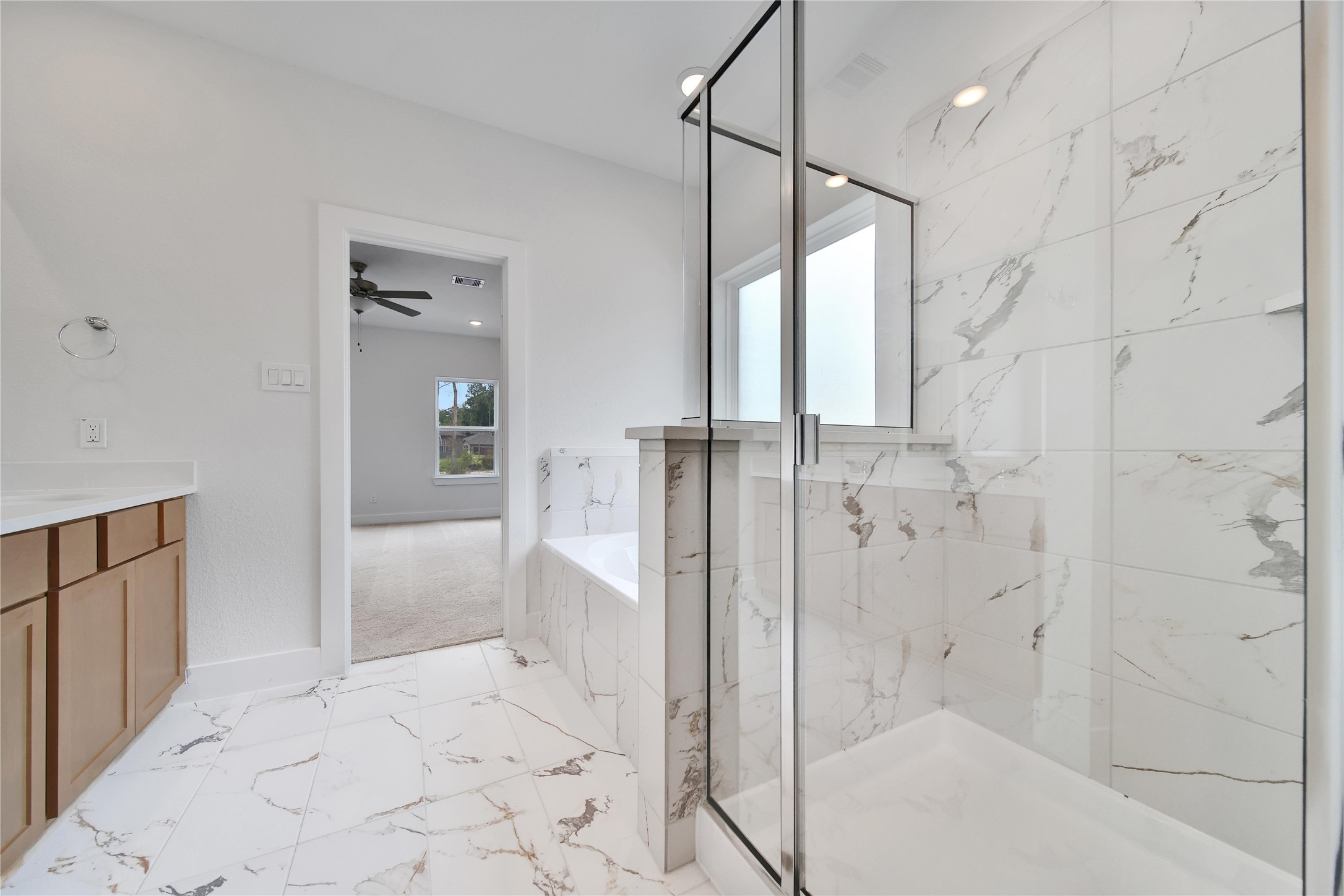 1003 Thor New Caney, TX 77357 - Photo 17 of 45 a bathroom with a glass shower door and a sink