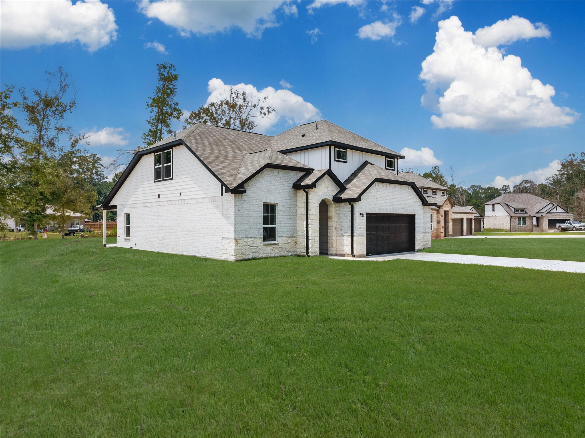 1003 Thor New Caney, TX 77357 - Photo 34 of 45 a view of a white house with a big yard potted plants and large tree
