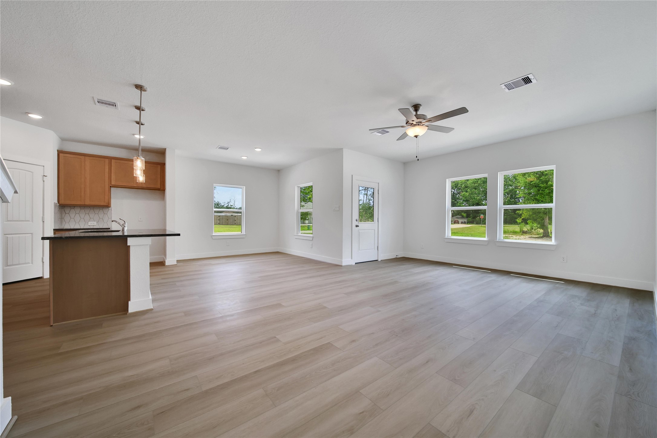 1003 Thor New Caney, TX 77357 - Photo 4 of 45 a view of an empty room with a kitchen and a window