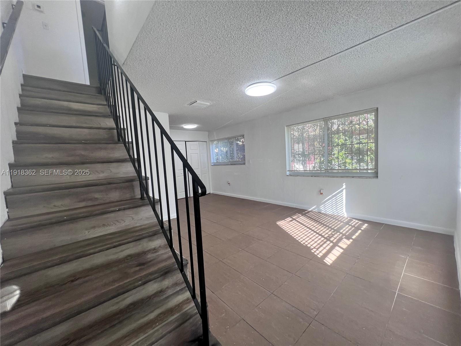 65 Northeast 59th Street, Unit 3 Miami, FL 33137 - Photo 2 of 10 a view of entryway and hall with wooden floor