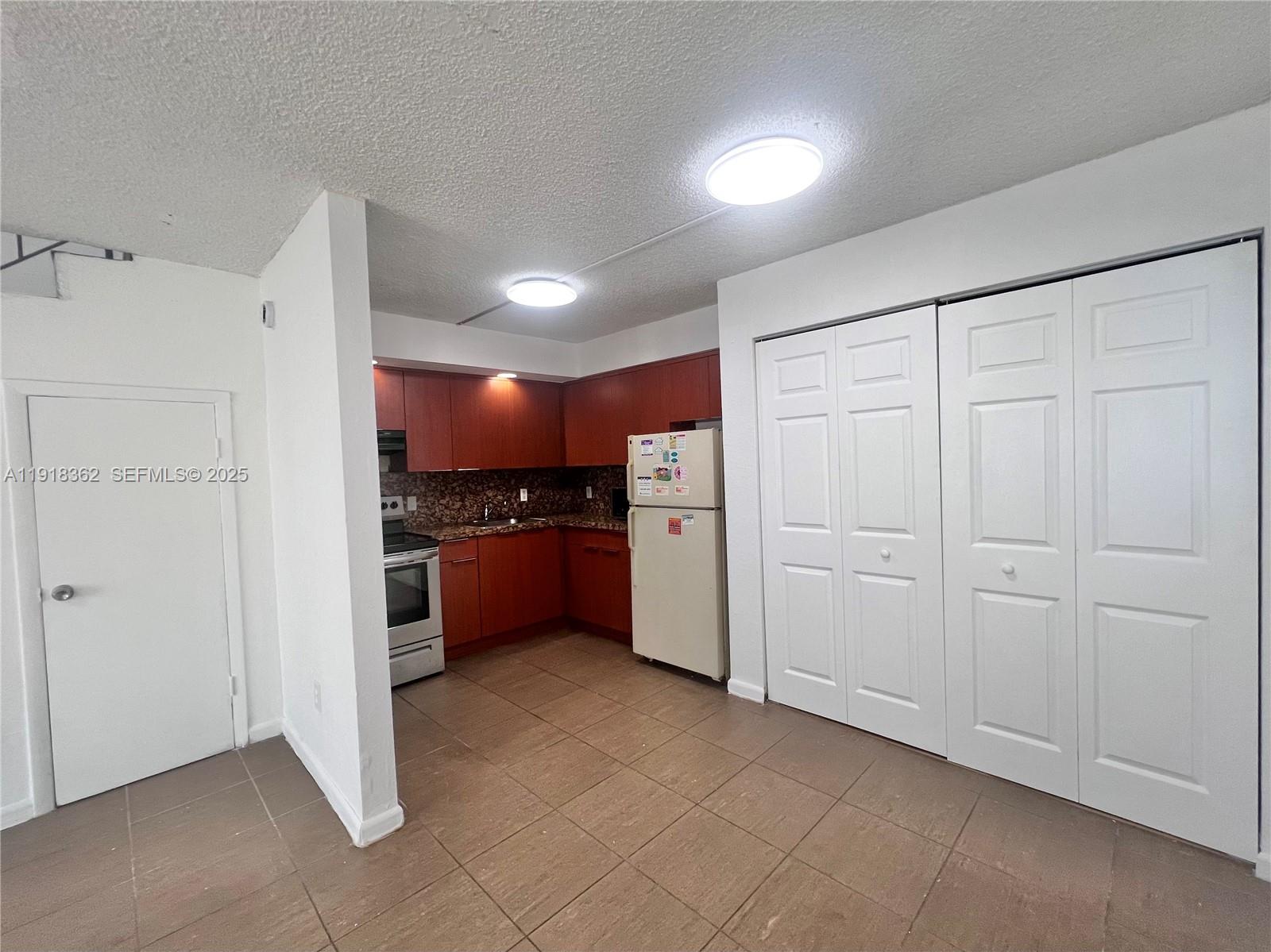 65 Northeast 59th Street, Unit 3 Miami, FL 33137 - Photo 4 of 10 a view of an empty room with a kitchen