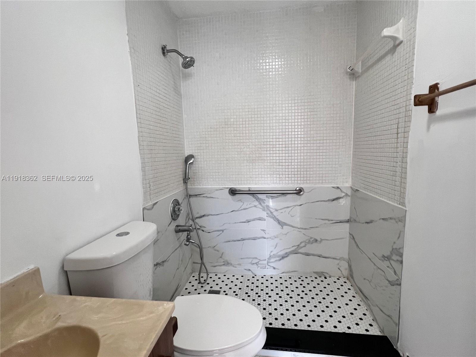 65 Northeast 59th Street, Unit 3 Miami, FL 33137 - Photo 8 of 10 a bathroom with a toilet and a shower