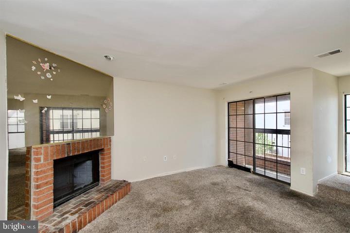 1818 Bryant Street Northeast Washington, DC 20018 - Photo 2 of 12 a view of an empty room with a fireplace and a window