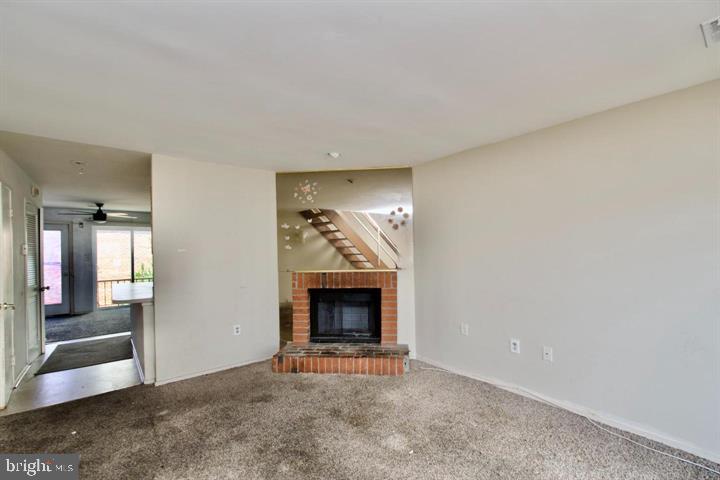 1818 Bryant Street Northeast Washington, DC 20018 - Photo 3 of 12 an empty room with wooden floor fireplace and windows