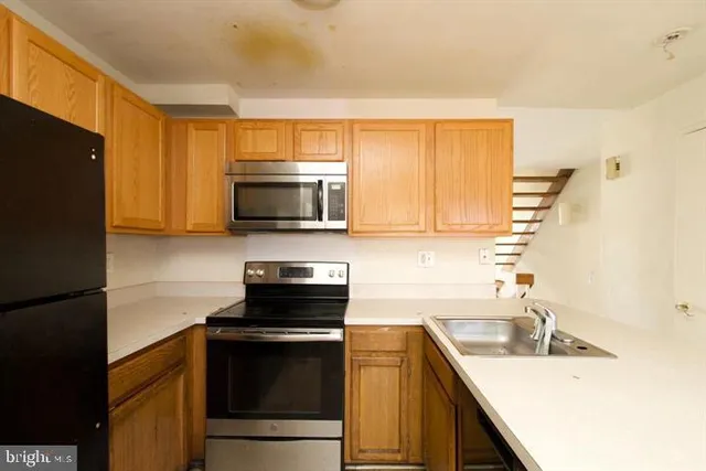 a kitchen with a sink stove and microwave